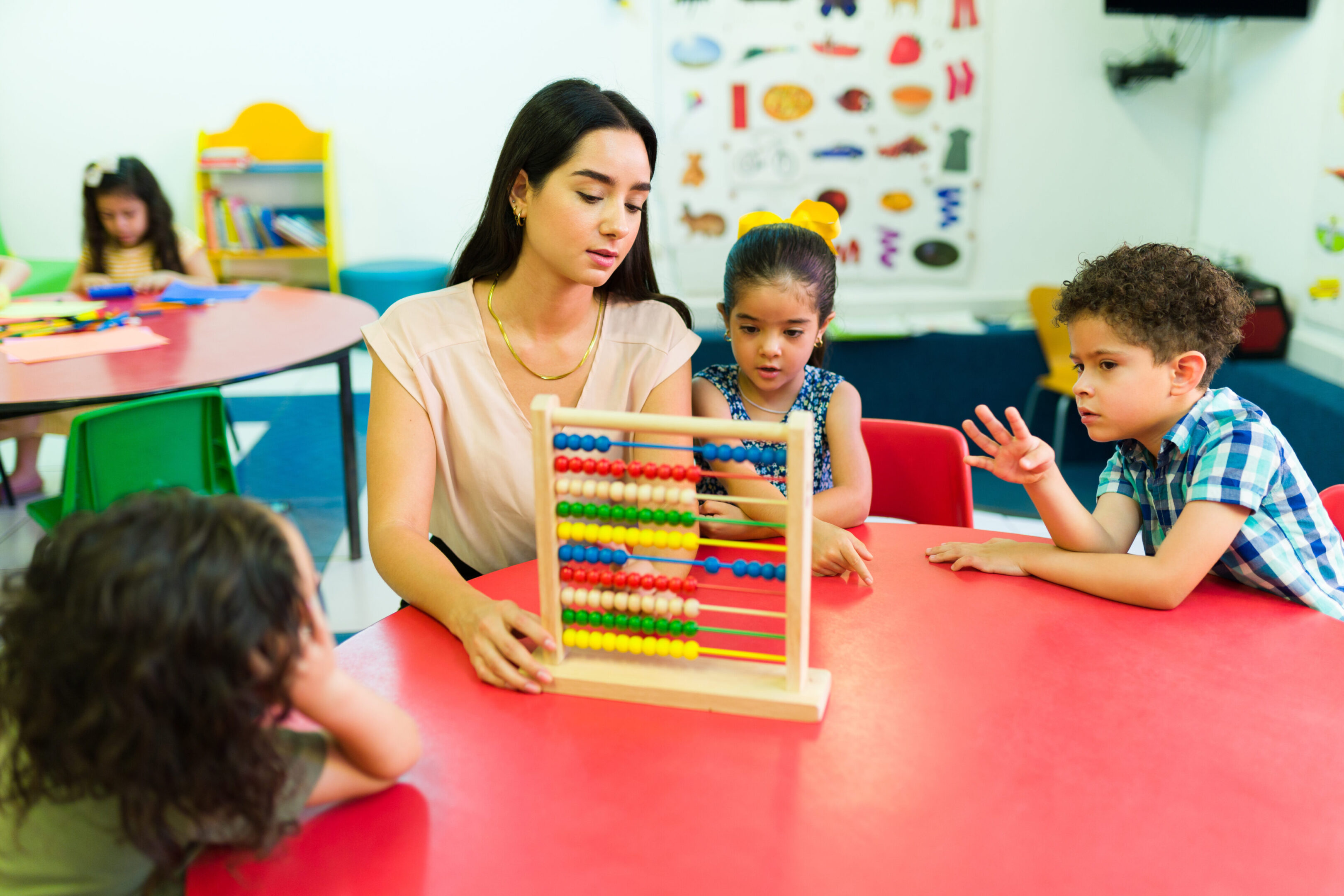 A woman and children are playing with an abacus.